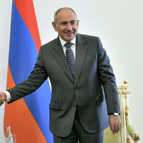 Armenia's Prime Minister Nikol Pashinyan (R) shakes hands with Iran's President Masoud Pezeshkian during his visit in Yerevan on July 19, 2025. (Photo by KAREN MINASYAN / AFP) (Photo by KAREN MINASYAN/AFP via Getty Images)