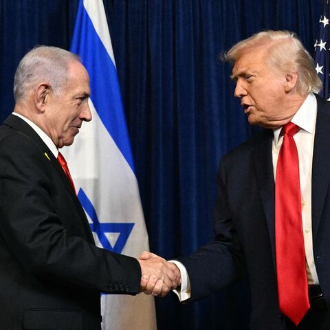 US President Donald Trump (R) and Israeli Prime Minister Benjamin Netanyahu shake hands as they arrive to speak to journalists during a joint press conference at Trump's Mar-a-Lago residence in Palm Beach, Florida, on Dec. 29, 2025. 