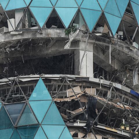 A photograph shows a damaged building in the aftermath of a drone strike in the Seef district of Manama on March 10, 2026. 