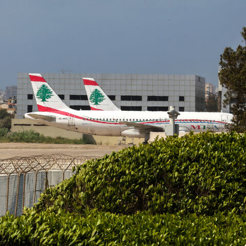 Middle East Airlines aircraft sit on the tarmac at Beirut's Rafik Hariri airport on April 10, 2026. Smoke from an Israeli strike still lingered in the air as a plane from Lebanon's national carrier took off from Beirut airport, which has stayed open despite the latest war between Israel and Hezbollah. The country's only international passenger facility, whose departure boards are now largely red with cancellations, is located on the Mediterranean coast at the edge of Beirut's southern suburbs. (Photo by Anw