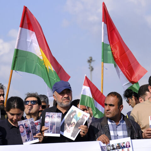 People wave flags of Kurdistan during a march in Erbil, Iraq, on April 21, 2026, expressing support for the unity of Iranian Kurdish parties and condemning Iranian missile strikes and military actions against Kurdish groups in the Kurdistan Region of Iraq. 