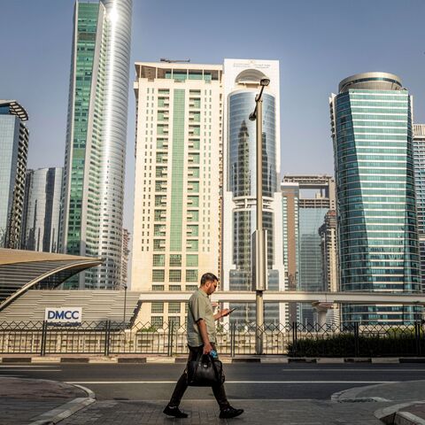 A man crosses a street while returning home from work, in Dubai on June 23, 2026. (Photo by FADEL SENNA / AFP via Getty Images)