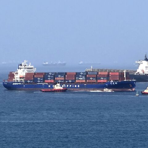 A cargo ship is pictured off coast of the Khor Fakkan Container Terminal, the only natural deep-sea port in the region and one of the major container ports in Sharjah Emirate, along the Gulf of Oman on June 28, 2026.