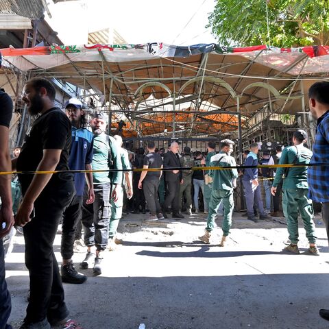 Syrian security forces and people gather at the site of an explosion at a cafe in the capital, Damascus, on July 2, 2026. 