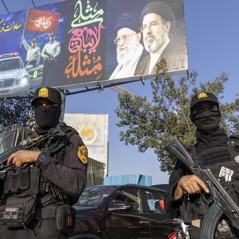 Iranian NOPO special police officers stand guard in front of a large portrait of Iran's late Supreme Leader, Ayatollah Ali Khamenei, at Valiasr square on July 3, 2026, in Tehran, Iran. 