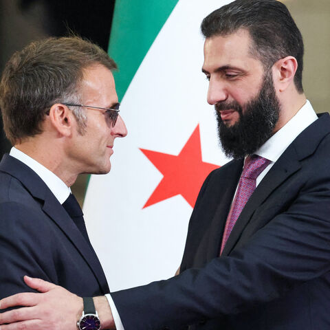 Syrian President Ahmed al-Sharaa (R) shakes hands with France's President Emmanuel Macron following a joint press conference in Damascus on July 7, 2026. 