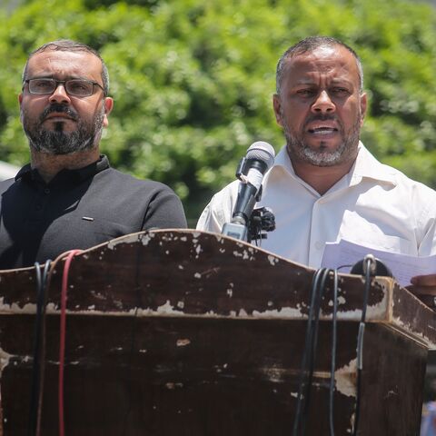 Government Media Office Director Ismail Thawabteh (R) and Hamas spokesperson Hazem Qassem (L) speak at a press conference.