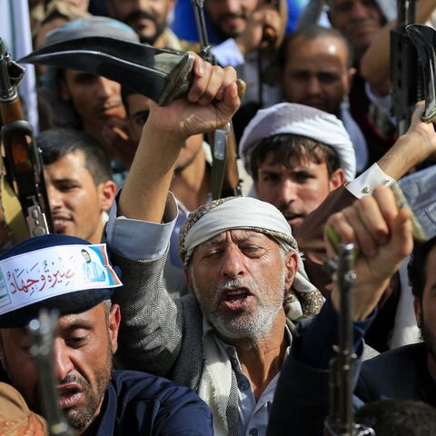Armed Yemeni supporters of the Iran-backed Houthi movement brandish their weapons during a protest against US strikes on Iran in Sanaa on July 10, 2026. 