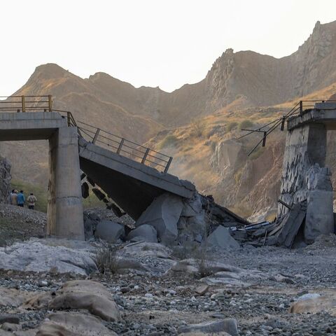 A heavily damaged bridge hit by a US strike is pictured along the road connecting Roudan and Bandar Abbas in southern Iran on July 18, 2026. — Amir Hossein KHORGOOEI / ISNA / AFP via Getty Images