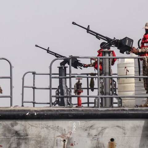 Sailors from the navy of Yemen's Aden-based internationally recognized government stand at machine-gun positions aboard a vessel patrolling a shipping lane off Hanish Island in the Red Sea on July 27, 2026. 
