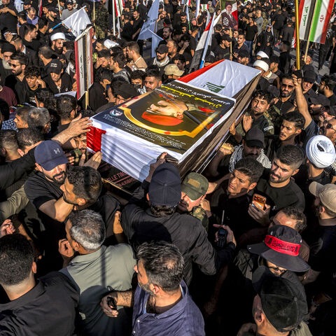 Mourners carry one of the bodies of members of Iraq's Hashed al-Shaabi, or Popular Mobilisation Forces (PMF) who were killed earlier in Diyala in central Iraq by US-Saudi strikes, during the funeral in Baghdad on July 29, 2026. The US-Saudi strikes killed at least 20 militants, including Iranians, according to the Hashed al-Shaabi. The US and Saudi Arabia said the strikes were in response to attacks on US forces and Saudi oil facilities. (Photo by murtadha ridha / AFP via Getty Images) /
