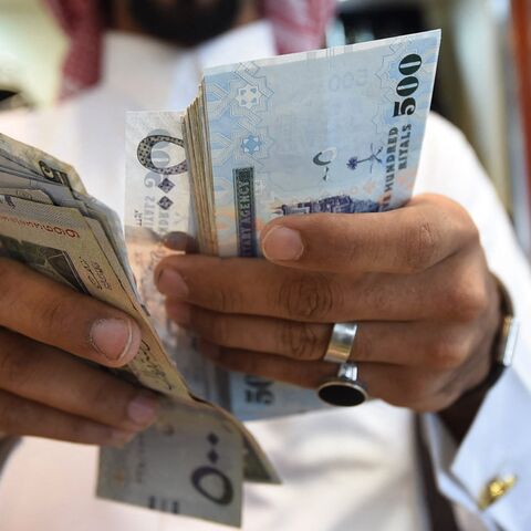A man counts Saudi riyal banknotes in the capital, Riyadh, Oct. 3, 2016.