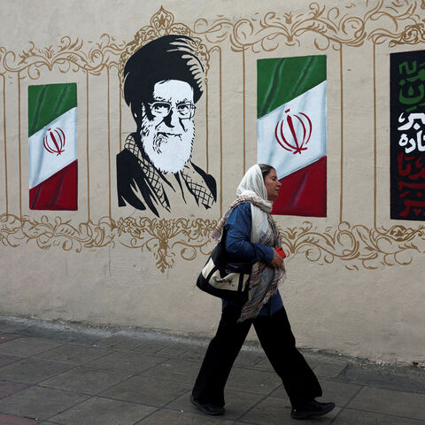 FILE PHOTO: A woman walks by a mural depicting Iran's late Supreme Leader Ayatollah Ali Khamenei, on a street in Tehran, Iran, August 13, 2026. Majid Asgaripour/WANA (West Asia News Agency) via REUTERS/File Photo