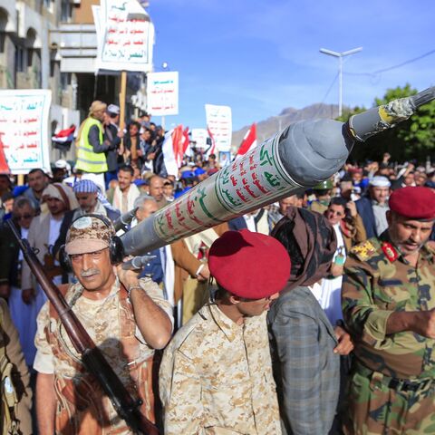 Supporters of Yemen's Houthi rebel movement carry a mock rocket as they demonstrate in the capital, Sanaa, to denounce a reported air strike by the Saudi-led coalition on a prison in the country's rebel-held north, on Jan. 21, 2022.