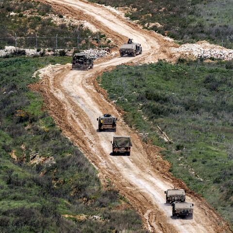 Israeli army vehicles move to a position in southern Lebanon, March 27, 2026.
