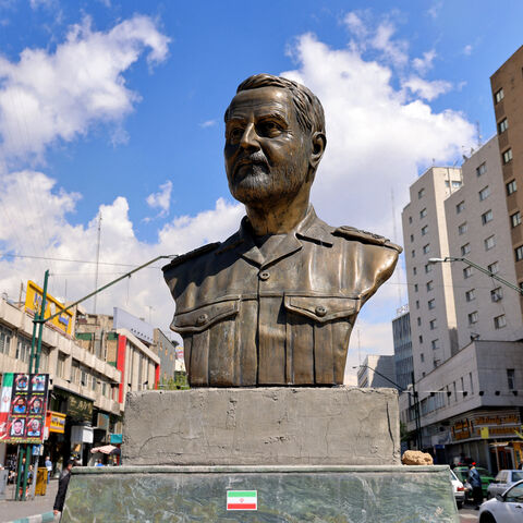 A memorial depicting Qassem Soleimani, the slain commander of the "Quds Force" of Iran's Islamic Revolutionary Guards Corps (IRGC), who was killed by a US airstrike in Iraq in 2020, is pictured at Valiasr Square in Tehran on April 6, 2026. Israeli strikes killed the intelligence chief of Iran's Revolutionary Guards, as the Islamic republic on April 6 defied threats from the US President to devastate civilian infrastructure if it does not reopen the Strait of Hormuz. (Photo by ATTA KENARE / AFP via Getty Ima