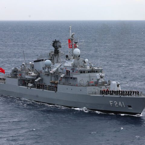 Servicemen of Yavuz class, TCG Turgutreis (F-241), warship stand at attention on the deck as they participate in the live-fire phase of the "Blue Homeland-2026" (Mavi Vatan) tactical military exercises in the eastern Mediterranean Sea, in Antalya on April 9, 2026.
