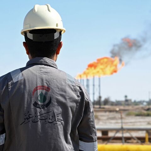 a worker inspects an oil field in Iraq