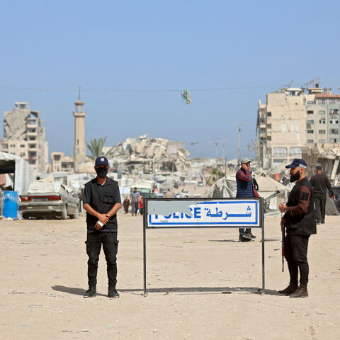 Palestinian militant group Hamas police officers stand guard as people attend the opening of the Fatah party's eighth general conference at Al-Azhar University in Gaza City on May 14, 2026. 
