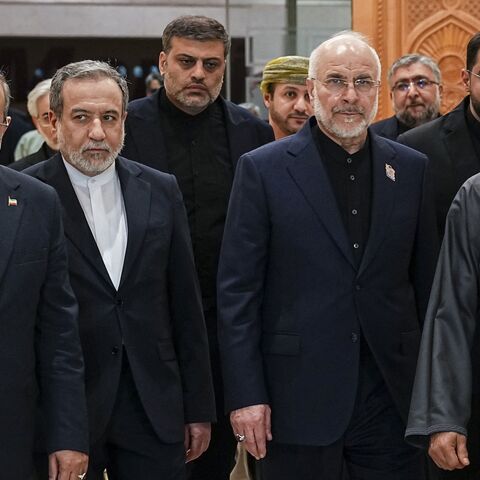 Iranian Foreign Minister Abbas Araghchi (2nd L), Iranian parliament speaker Mohammad Bagher Ghalibaf (2nd R) and Omani Foreign Minister Badr bin Hamad Al-Busaidi (R) walk inside a building in Muscat, Oman, on June 22, 2026. 
