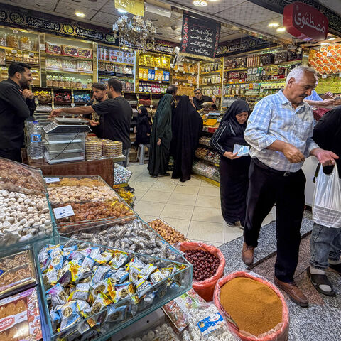 People shop at a store in the Grand Reza Bazaar near the shrine of Imam Reza following the funeral of slain Iranian leader Ali Khamenei and his family members in Mashhad on July 10, 2026. 