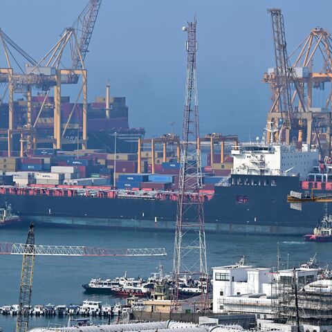 Ships are docked along a pier at the Khor Fakkan Container Terminal, the only natural deep-sea port in the region and one of the major container ports in Sharjah Emirate, along the Gulf of Oman on July 14, 2026. 