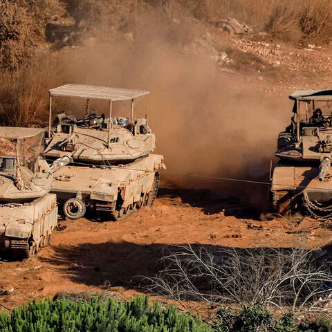 Israeli battle tanks deploy in the village of Zawtar al-Sharqiyah (Eastern Zawtar) in southern Lebanon as pictured from the nearby village of Zawtar al-Gharbiyah (Western Zawtar) on August 2, 2026. Under a US-sponsored agreement signed in June, Lebanon's army is to disarm Hezbollah and the Israeli military is to withdraw from "pilot zones" where Lebanese forces will subsequently deploy. The deal came more than three months after Hezbollah drew Lebanon into the Middle East with rocket fire at Israel in suppo