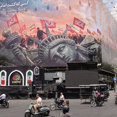 Iranians drive past an anti-US billboard at Enghelab Square in central Tehran, Aug. 3, 2026. — ATTA KENARE / AFP via Getty Images