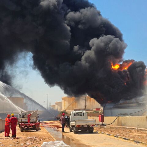 Libyan firefighting teams attempt to extinguish a fire at the Zawiya refinery, the second-largest oil refinery in Libya, with a refining capacity of 120,000 barrels per day, after a tank belonging to the state-owned Libyan Brega Oil Company was attacked by unknown perpetrators, in Zawiya, Libya, on Aug. 11, 2026.