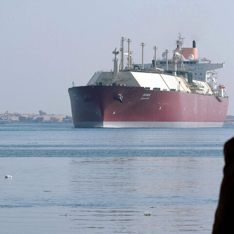 A man looks at a Qatari liquefied natural gas carrier as its passes through the Suez Canal near Ismailia, Egypt, April 1, 2008. — -/AFP via Getty Images