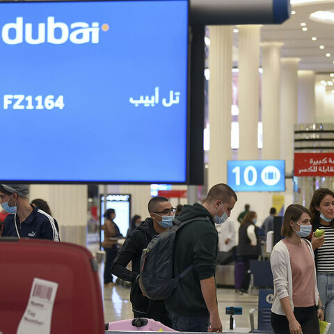 Israelis pick up their luggage upon arrival from Tel Aviv to the Dubai airport in the United Arab Emirates, on Nov. 26, 2020, on the first scheduled commercial flight operated by budget airline flydubai.