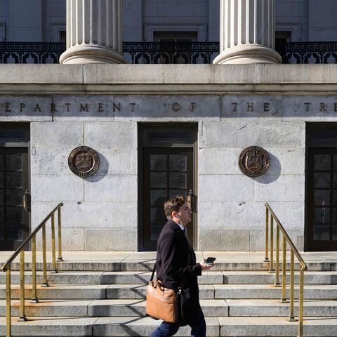 A pedestrian passes by the Treasury Building in Washington, DC on Jan. 18, 2023. 