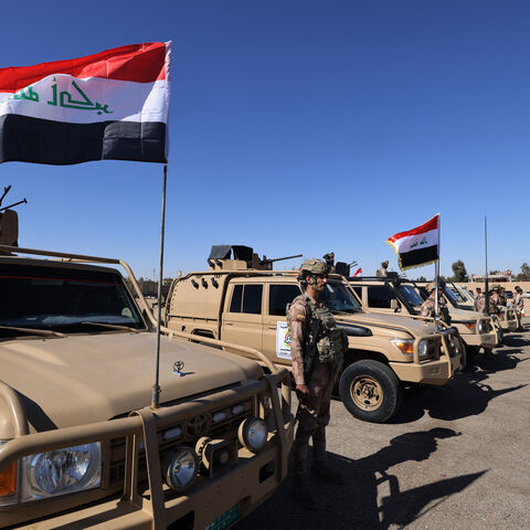 Iraqi soldiers from the new 'desert battalion' special forces stand next to military vehicles as the take part in a graduation ceremony, after months of training by the French military, at the Ain al-Asad air base in Anbar west of Baghdad on February 29, 2024. (Photo by Ahmad AL-RUBAYE / AFP) (Photo by AHMAD AL-RUBAYE/AFP via Getty Images)