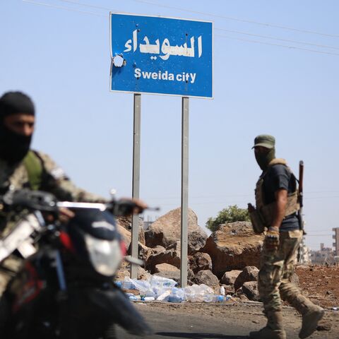 Tribal and Bedouin fighters deploy in the western neighborhood of southern Syria's predominantly Druze city of Suwayda amid clashes with Druze gunmen on July 19, 2025. 