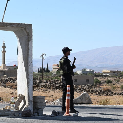 A member of Syria's security forces stands guard outside a former army base near the city of Quneitra in southern Syria, on the edge of the Israeli-annexed Golan Heights on Sept. 21, 2025. 