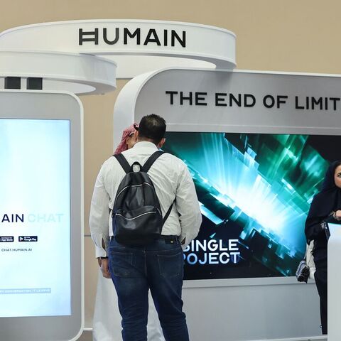 Guests stand at the booth of Saudi artificial intelligence company Humain during the Future Investment Initiative (FII) conference in Riyadh, on Oct. 29, 2025. — FAYEZ NURELDINE/AFP via Getty Images