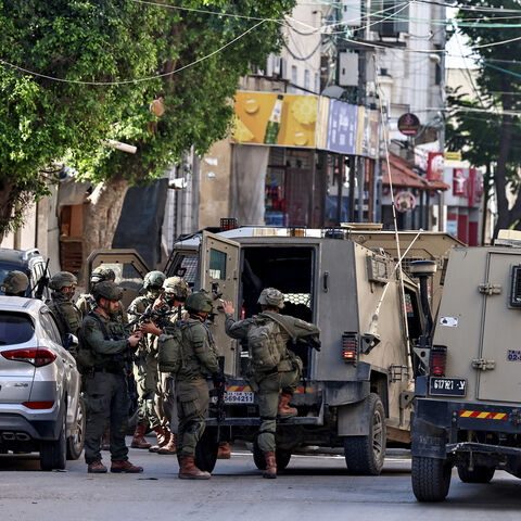 Israeli soldiers take positions during a military operation in the town of Qalqiya, in the occupied West Bank, Dec. 4, 2025. 