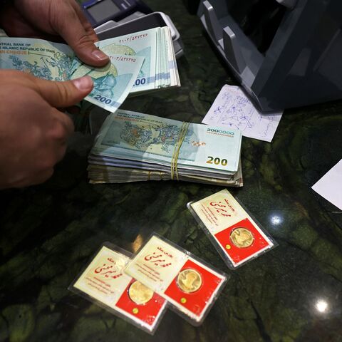 A man counts Iranian rial notes