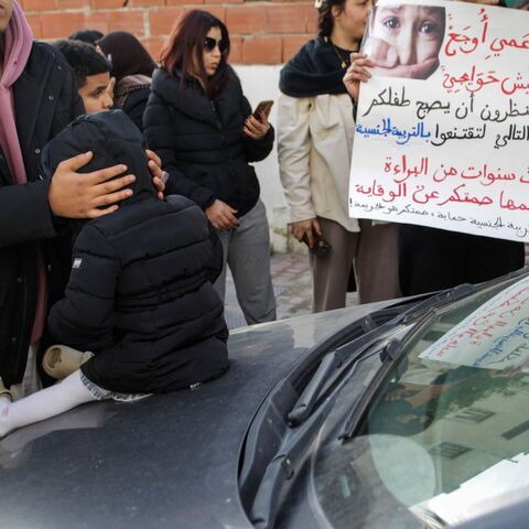 Protesters hold banners calling for child protection and justice