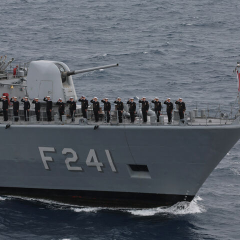 Servicemen of Yavuz class, TCG Turgutreis (F-241) warship, stand at attention on the deck as they participate in the live-fire phase of the "Blue Homeland-2026" (Mavi Vatan) tactical military exercises in the eastern Mediterranean Sea, in Antalya on April 9, 2026. 