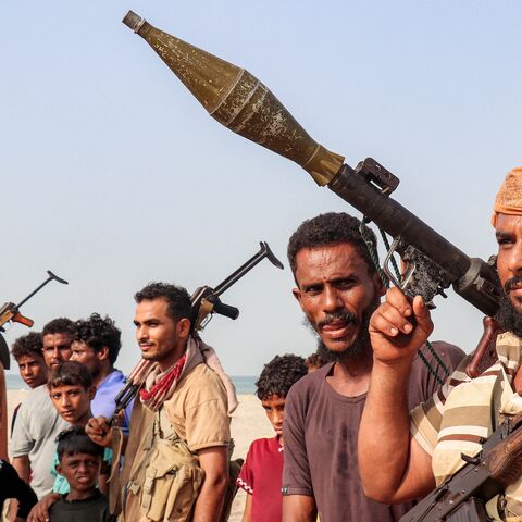 Fighters supporting the Aden-based, internationally recognized Yemeni government gather during a vigil along the Red Sea shore in Khokha, in Yemen's western Hodeidah province, on July 20, 2026. 