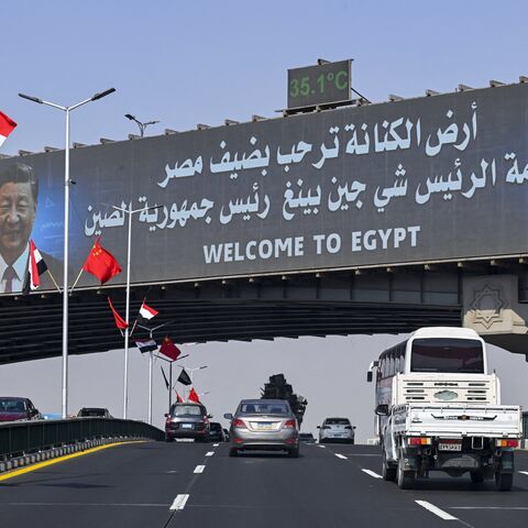 Vehicles drive beneath a large screen displaying portraits of Egypt's President Abdel Fattah al-Sisi (R) and his Chinese counterpart, Xi Jinping, in Cairo on Aug. 31, 2026.