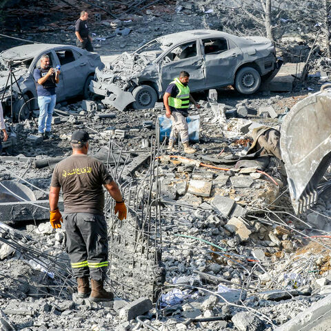 An excavator digs as rescuers search for survivors amid the rubble following an overnight Israeli airstrike on the village of Kfar Roummane, southern Lebanon, Sept. 7, 2026.