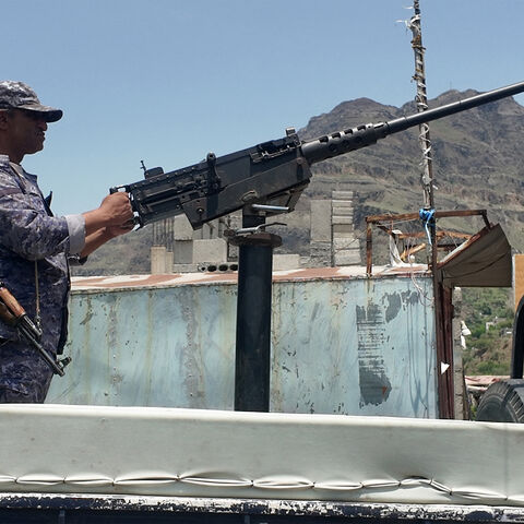 A member of the Saudi-backed Yemeni government forces, including National Army and Taiz Axis forces, mans a turret mounted on the back of a pickup truck at a checkpoint along the Kadha frontline west of Taiz in western Yemen on Sept. 13, 2026. 