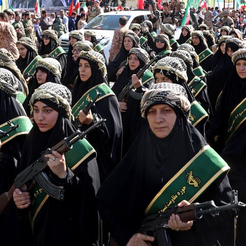 Members of Iran's Basij paramilitary force march with riffles during a military rally named Jan-Fada in Tehran, Sept. 18, 2026.
