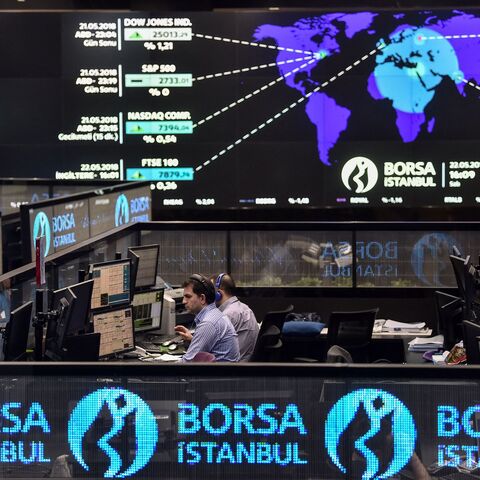 Traders work at their desks on the floor of the Borsa Istanbul 