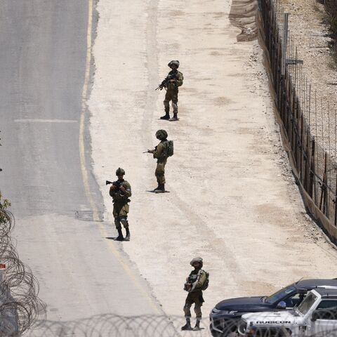 Israeli troops stand guard on the dividing line between the Israeli-annexed Golan Heights and Syrian, near Majdal Shams, July 16, 2025.