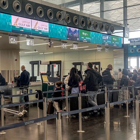 Travelers queue to check in their luggage at the terminal at King Khalid International Airport in Riyadh, on March 10, 2026. 