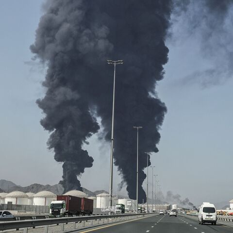 TOPSHOT - Smoke rises from the direction of an energy installation in the Gulf emirate of Fujairah on March 14, 2026. Smoke could be seen rising from the direction of a major UAE energy installation on March 14, in what appeared to be the latest strike targeting the Gulf's petroleum facilities hours after the US struck Iran's Kharg Island. (Photo by AFP via Getty Images) /