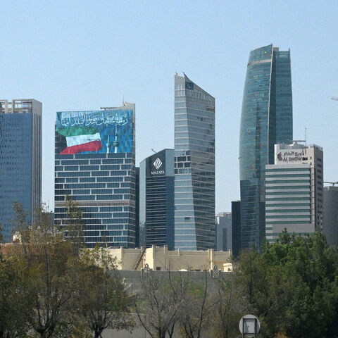 A large screen displays a verse from the Koran reading "My Lord, make this city secure," alongside the Kuwaiti flag and the landmark Kuwait Towers, on a skyscraper in Kuwait City on Sept. 2, 2026.